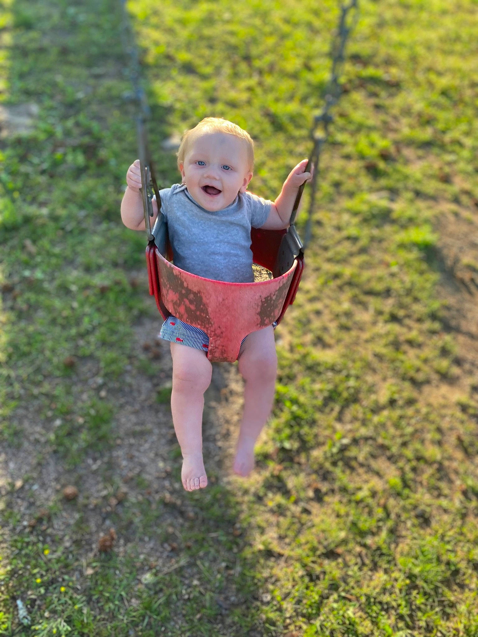 Izaiah joined the competition — help win amazing prizes! baby, baby_toddler_clothing, barefoot, child, fun, grass, grassland, happy, landscape, leisure, people_in_nature, person, plant, play, playground, recreation, soil, spring, swing, t_shirt