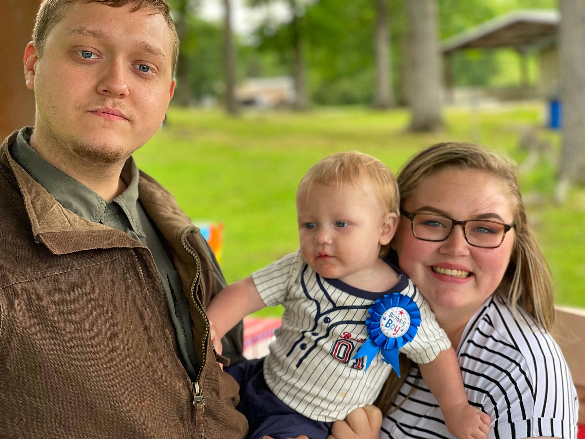 Izaiah is registered to the contest to win money with this photo: baby, baby_toddler_clothing, daytime, eye, face, family_taking_photos_together, fun, grass, happy, head, iris, joy, leaf, people, people_in_nature, person, plant, skin, smile, social_group