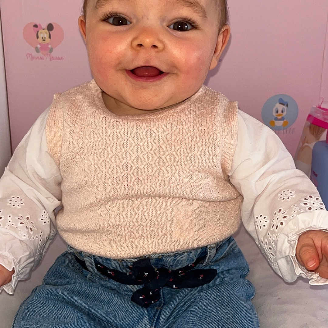 Kayla participe au concours pour gagner de l'argent avec cette photo : baby, bodypart, clothing, face, finger, hand, happy, head, jeans, knitwear, mouth, pants, person, photography, portrait, shorts, sitting, smile, sweater, teeth