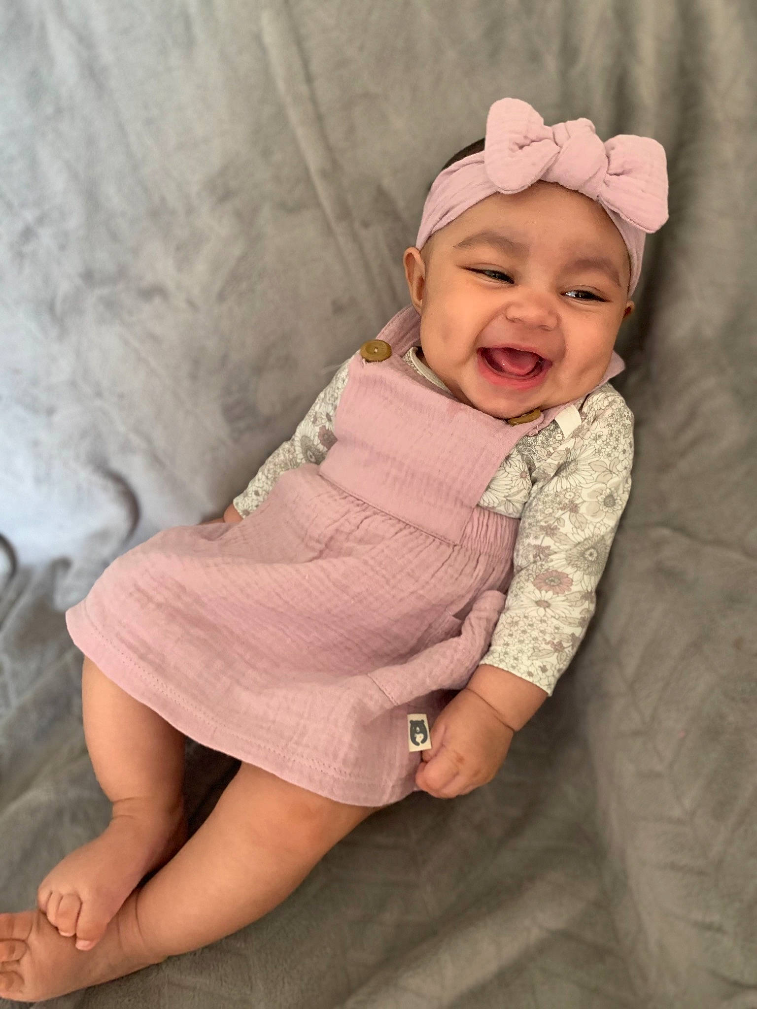 Aleena is registered to the contest to win money with this photo: baby, baby_toddler_clothing, blond, cap, child, collar, comfort, dress, happy, headwear, human_leg, knee, leg, lip, pattern, person, pink, skin, sleeve, smile