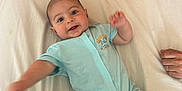 Ethan participe au concours pour gagner de l'argent avec cette photo : baby, infant, smiling, onesie, bed, pillow, blanket, happy, child, human, skin, face, arm, leg, indoor, cute, young, person, lying_down, playful