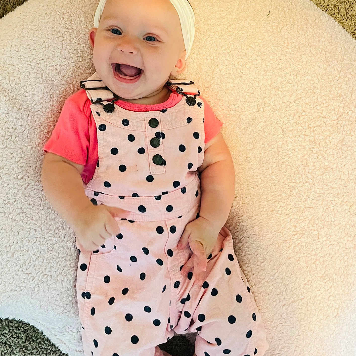 Laynie is registered to the contest to win money with this photo: baby, bow, carpet, child, cushion, cute, fashion, feet, hands, happy, headband, indoor, infant, overalls, pink_clothing, playful, polka_dots, portrait, smiling, toddler