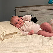 Laynie is registered to the contest to win money with this photo: baby, infant, bed, pillow, blanket, sleepwear, person, indoors, resting, cute, child, headboard, soft_lighting, comfort, skin, smile, casual, portrait, young, relaxing