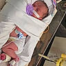 newborn, baby, hospital, pacifier, blanket, medical_sensor, swaddled, infant, sleeping, bassinet, diaper, foot_bandage, hospital_equipment, indoors, healthcare, person, cute, resting, tubing, monitoring