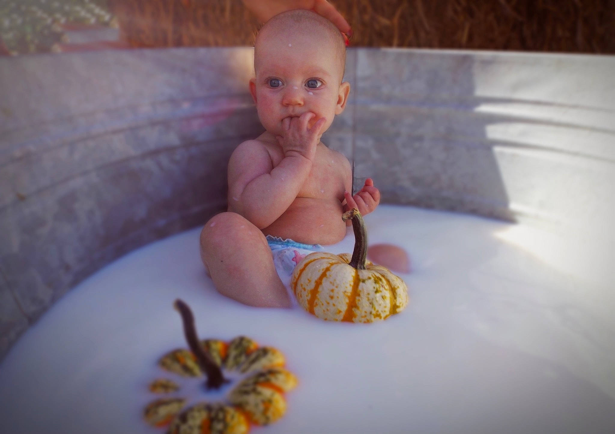 Zaria is registered to the contest to win money with this photo: baby, baby_toddler_clothing, child, comfort, couch, finger, floor, flooring, foot, fun, happy, human_leg, leisure, orange, person, room, sitting, skin, textile, toddler