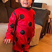 Leandro a rejoint le concours — aidez-le/la à gagner de superbes lots ! black_spots, blanket, candid, child, costume, hair, home, indoors, ladybug_costume, living_room, playful, portrait, red_clothing, safety_gate, smile, socks, sofa, standing, tiled_floor, young_child