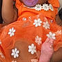adorable, baby, car_seat, child, closeup, comfort, cute, expression, floral_pattern, foot, hand, infant, lying_down, orange_dress, pacifier, portrait, rest, skin, sleepy, soft_toys