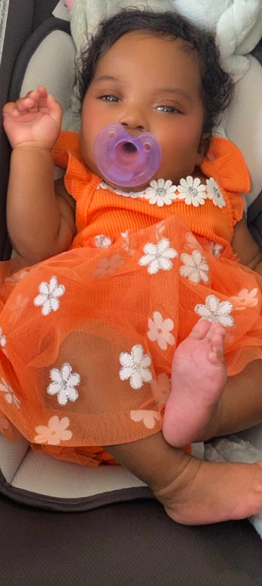 Madinah joined the competition — help win amazing prizes! adorable, baby, car_seat, child, closeup, comfort, cute, expression, floral_pattern, foot, hand, infant, lying_down, orange_dress, pacifier, portrait, rest, skin, sleepy, soft_toys