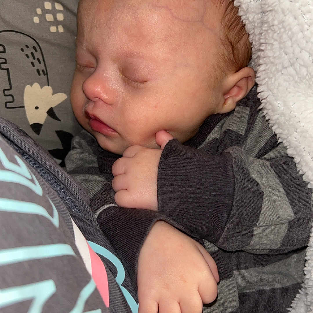 Evan is registered to the contest to win money with this photo: baby, bed, bedroom, blanket, bodypart, couch, cushion, face, finger, furniture, hand, head, homedecor, newborn, person, photography, portrait, quilt, sleeping, towel