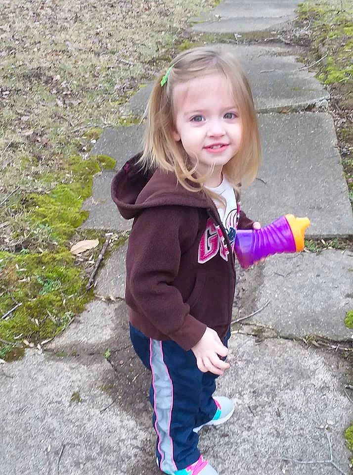 Reagan is registered to the contest to win money with this photo: blond, child, face, fun, grass, jacket, joy, long_hair, outerwear, person, plant, play, skin, smile, toddler, tree, vacation, winter