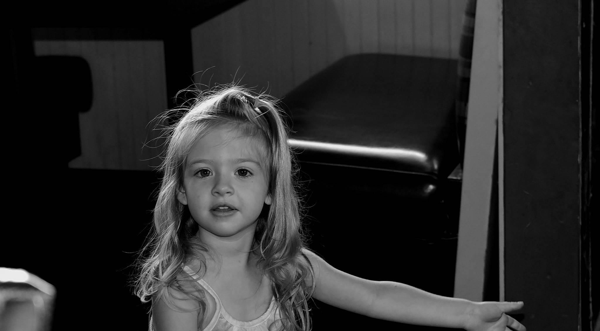 Reagan is registered to the contest to win money with this photo: black, black_and_white, blond, child, eye, face, flash_photography, fun, hair, hairstyle, head, monochrome, monochrome_photography, person, photograph, photography, room, smile, snapshot, standing