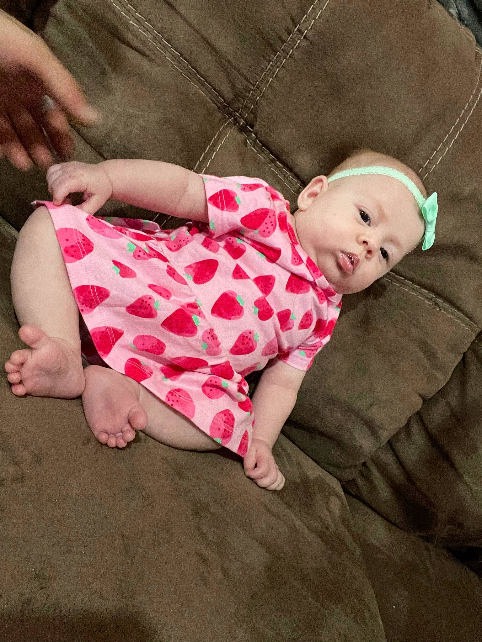 Lilah joined the competition — help win amazing prizes! baby, baby_toddler_clothing, child, clothing, comfort, foot, gesture, grass, head, human_body, knee, leg, linens, person, pink, plaid, skin, sleeve, thigh, toddler