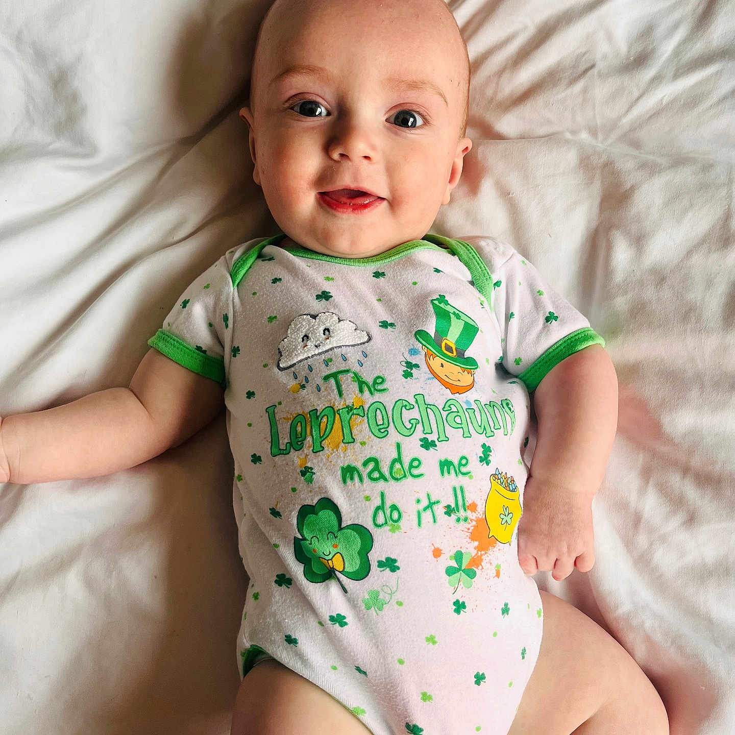 Elijah is registered to the contest to win money with this photo: baby, babylaughing, bed, clothing, couch, cushion, face, furniture, happy, head, homedecor, newborn, person, photography, portrait, sitting, sleeve, smile, standing, t_shirt