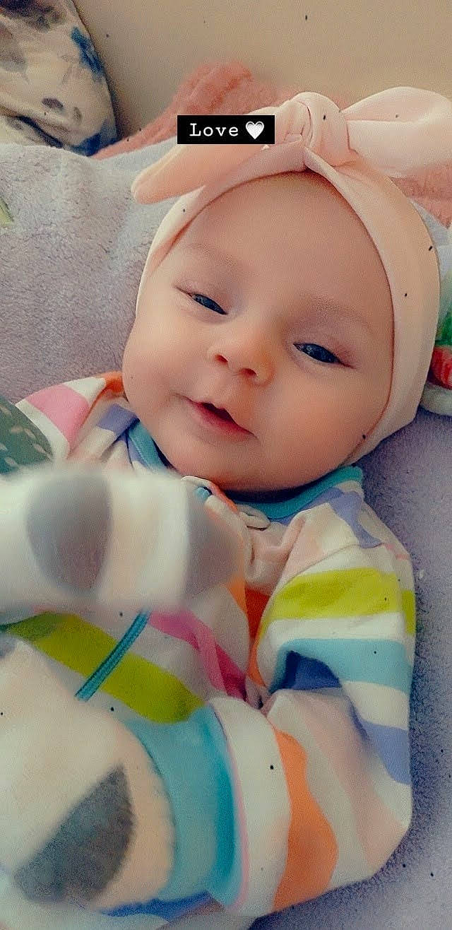 Preslee is registered to the contest to win money with this photo: baby, baby_products, baby_toddler_clothing, cap, cheek, child, comfort, eye, eyelash, face, fashion_accessory, fun, happy, hat, headgear, headwear, person, personal_protective_equipment, pink, skin