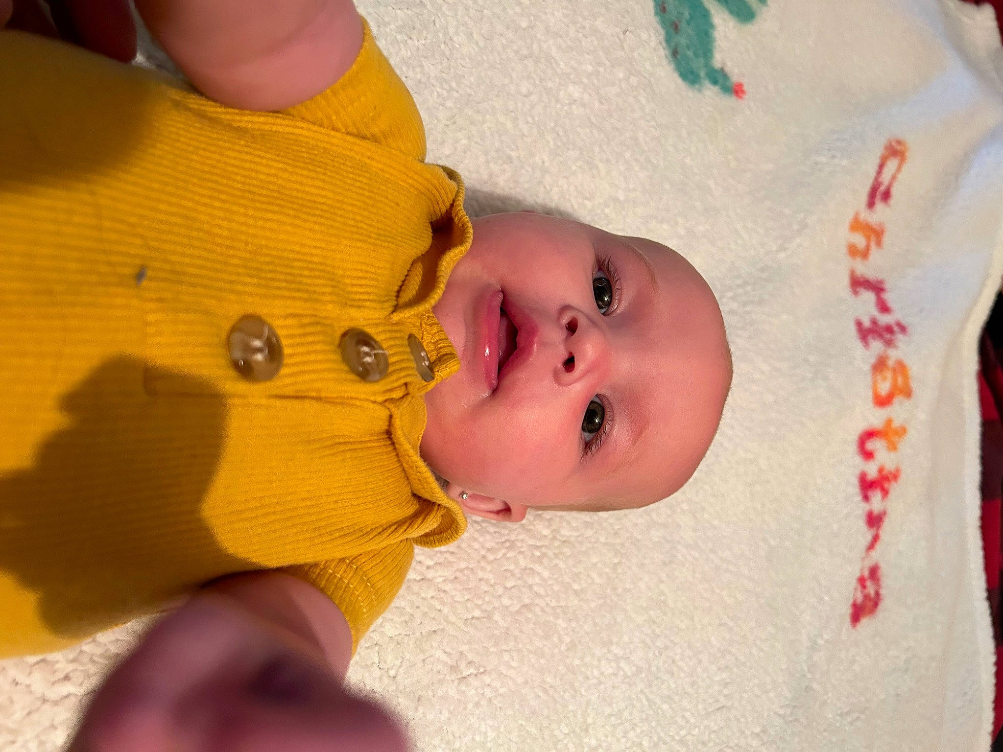 Christina is registered to the contest to win money with this photo: baby, baby_products, baby_toddler_clothing, cheek, child, chin, close_up, eye, eyelash, finger, gesture, happy, iris, lip, nose, person, product, skin, textile, thumb