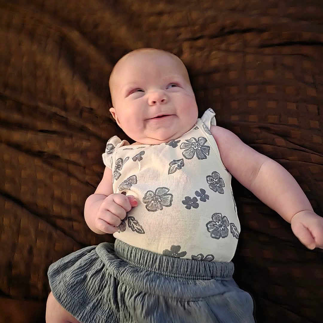 Kaliyah is registered to the contest to win money with this photo: baby, bodypart, clothing, couch, cushion, dress, face, finger, furniture, hand, head, homedecor, newborn, pants, person, photography, portrait, sitting, skirt, sleeve