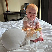 Kaliyah joined the competition — help win amazing prizes! baby, child, plush_toy, unicorn, bed, bedroom, lamp, table, chair, toy, soft_toy, infant, person, furniture, white_bedding, cute, indoor, young_child, carpet, curtain