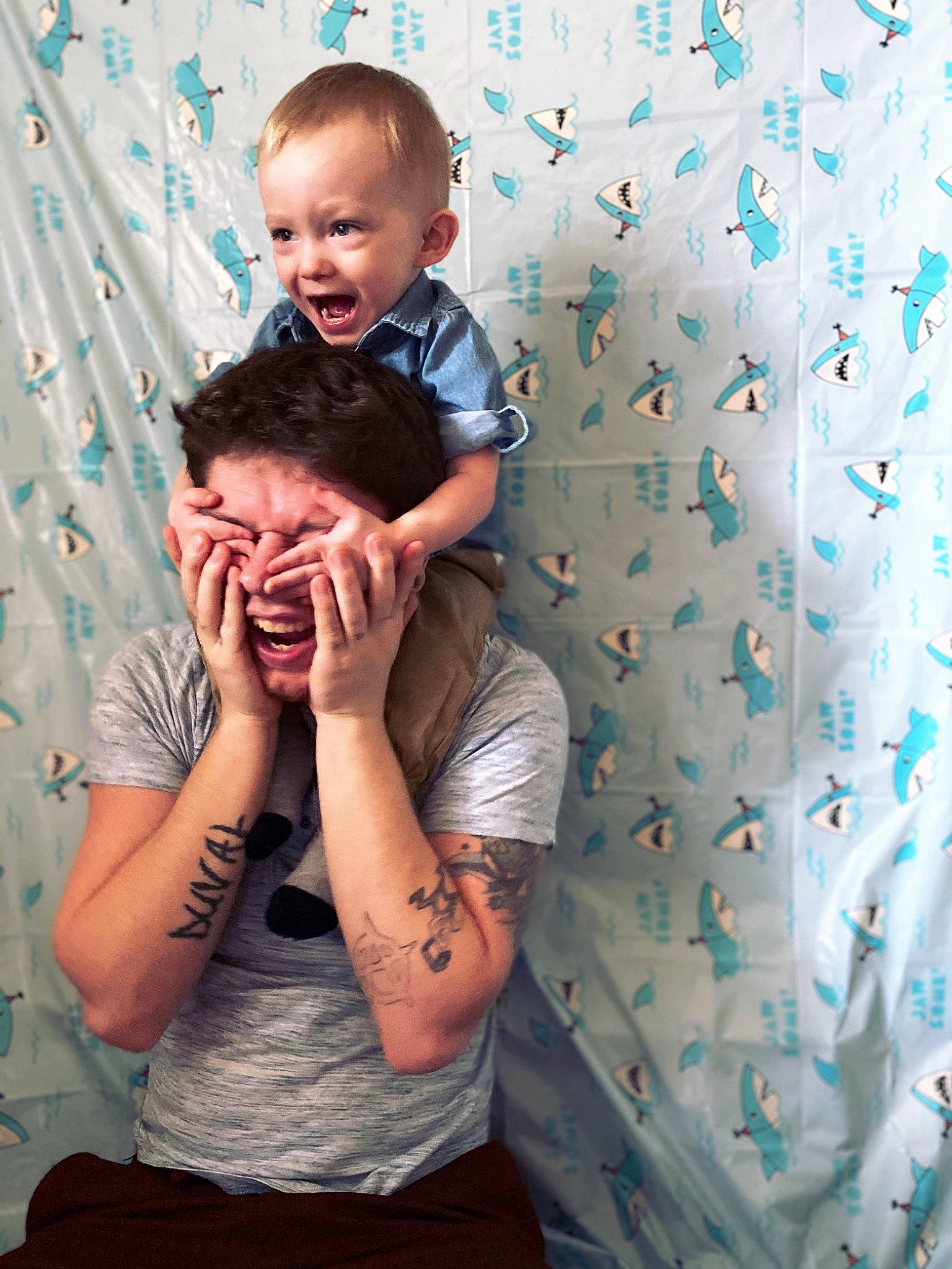 Hendrix is registered to the contest to win money with this photo: arm, baby, blue, child, family, gesture, happy, hug, human, love, pattern, people, person, photography, play, portrait, room, sitting, skin, smile