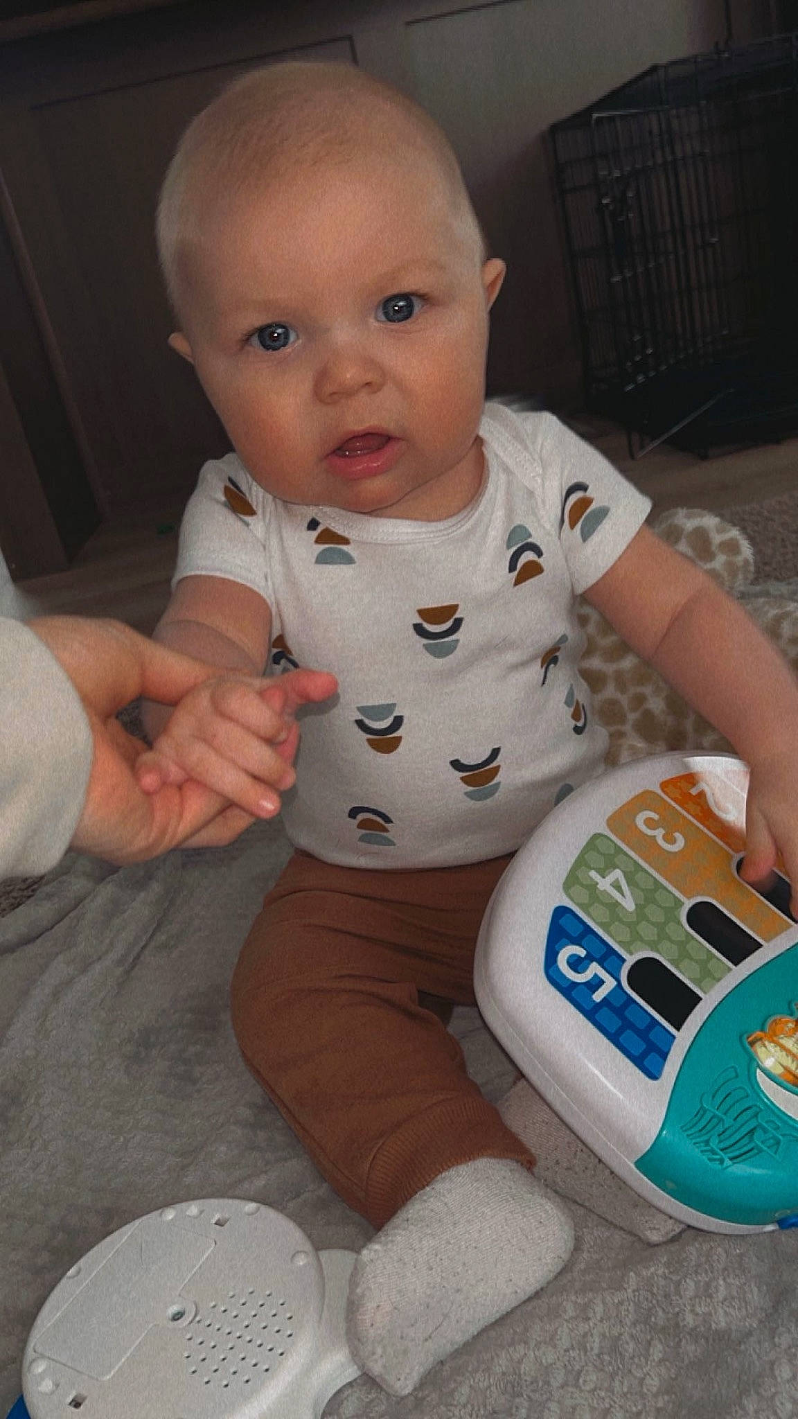 Aiden is registered to the contest to win money with this photo: arm, baby, baby_toddler_clothing, cheek, chest, child, comfort, finger, flooring, hand, household_supply, human_body, person, plastic_bottle, product, sitting, sleeve, thigh, thumb, toddler
