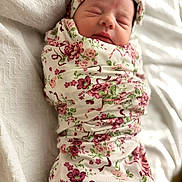 Amberley joined the competition — help win amazing prizes! baby, newborn, swaddle, blanket, floral_pattern, headband, sleeping, closed_eyes, peaceful, portrait, indoor, bed, bedding, fabric, clothing, infant, cute, pink, soft_texture, wrapped