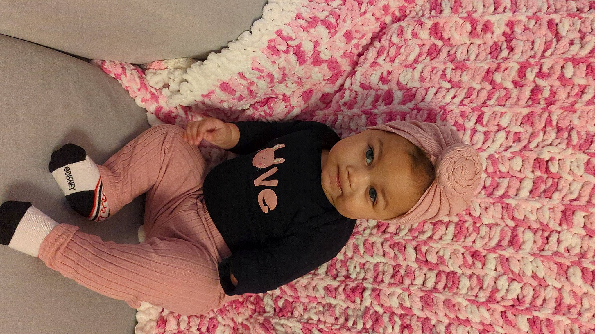 Lily is registered to the contest to win money with this photo: baby, baby_products, baby_toddler_clothing, cheek, child, comfort, fun, happy, human_body, linens, magenta, pattern, person, pink, room, sitting, skin, sleeve, smile, thigh