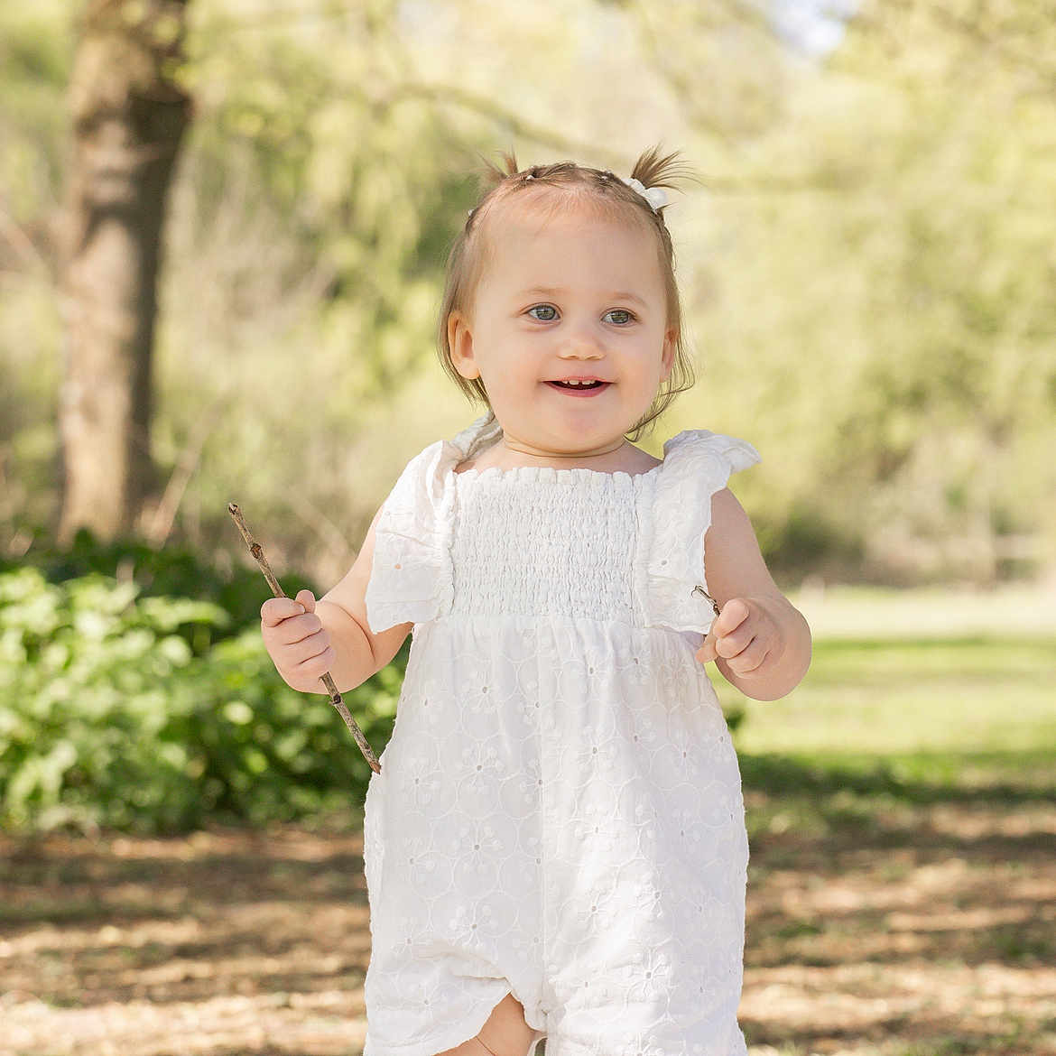 Lou participe au concours pour gagner de l'argent avec cette photo : baby, blonde, bodypart, clothing, dress, face, finger, formalwear, grass, hair, hand, happy, head, person, photography, plant, portrait, smile, standing, tree