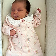 Delilah joined the competition — help win amazing prizes! baby, newborn, sleeping, pink_clothing, onesie, peter_rabbit, infant, bassinet, quilted, soft_fabric, face, hand, closed_eyes, cute, peaceful, child, portrait, indoors, resting, cozy