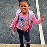 Kennedi is registered to the contest to win money with this photo: child, girl, smiling, standing, sidewalk, backpack, peace_sign, pink_sweatshirt, leggings, black_shoes, hairstyle, double_buns, book, outdoor, pavement, casual_clothing, cute, happy, person, daylight