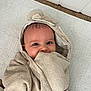 Kiara is registered to the contest to win money with this photo: baby, towel, hood, cute, smile, face, blue_eyes, infant, wrapped, floor, rug, texture, ears, child, indoors, playful, blanket, happy, person, closeup
