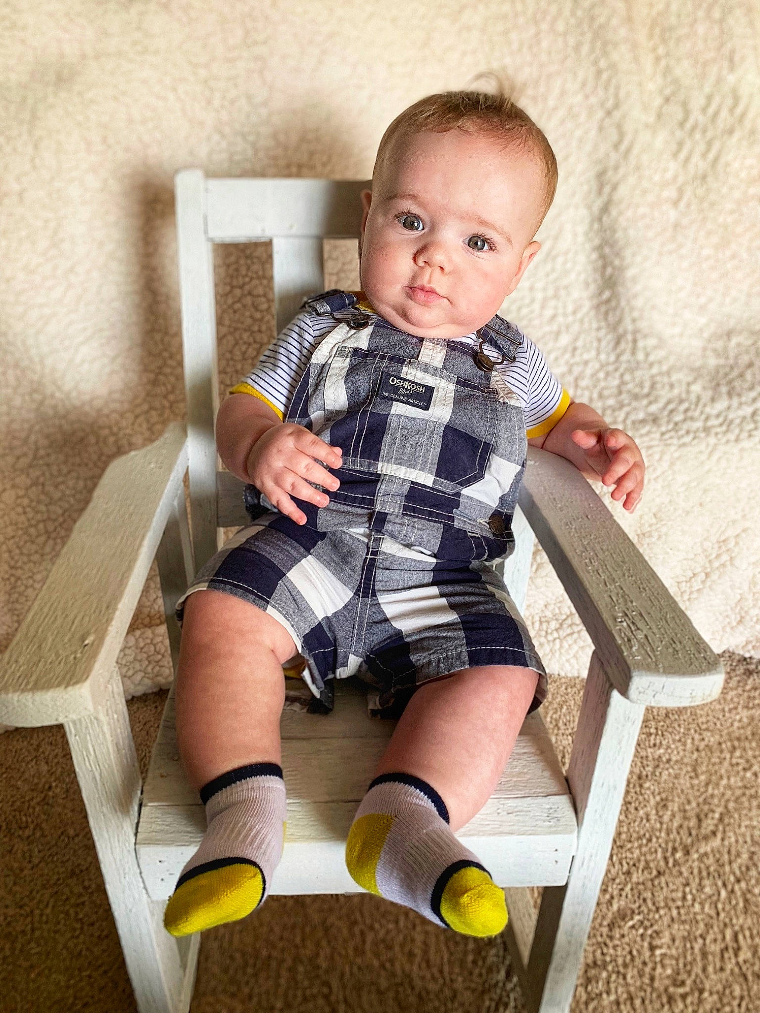 Duke is registered to the contest to win money with this photo: baby, baby_toddler_clothing, cheek, child, child_model, design, finger, footwear, knee, leg, pattern, person, plaid, play, product, sitting, standing, stock_photography, toddler, wood