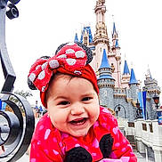 Lilith joined the competition — help win amazing prizes! architecture, bow, castle, child, daytime, happy, heart_pattern, ironwork, outdoor, people, person, polka_dot, portrait, red_headband, smiling, street_lamp, sweater, theme_park, toddler, tourist