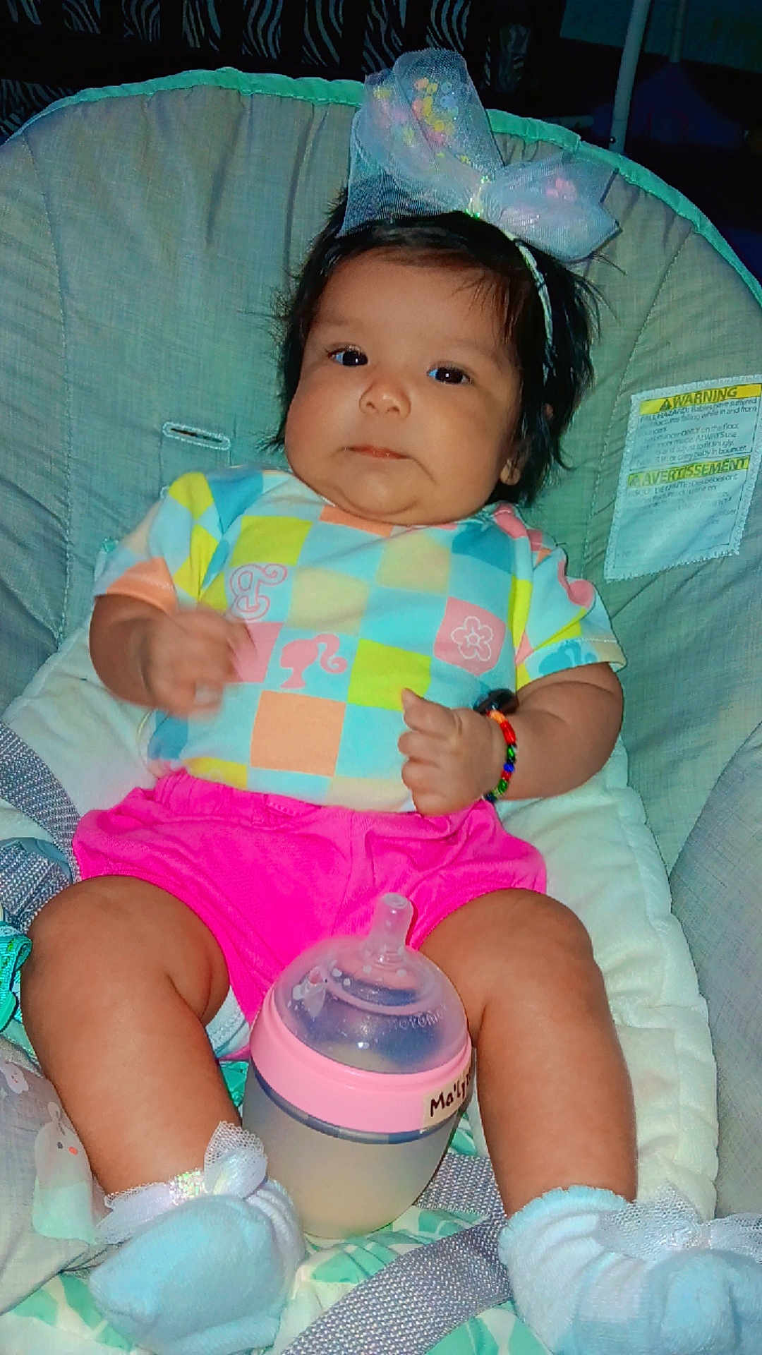 Ma'Lyzza joined the competition — help win amazing prizes! baby, infant, bottle, baby_seat, bow, colorful_clothing, pink_shorts, socks, bracelet, indoor, cute, child, face, headband, seat_belt, chubby_legs, expression, person, young_child, resting
