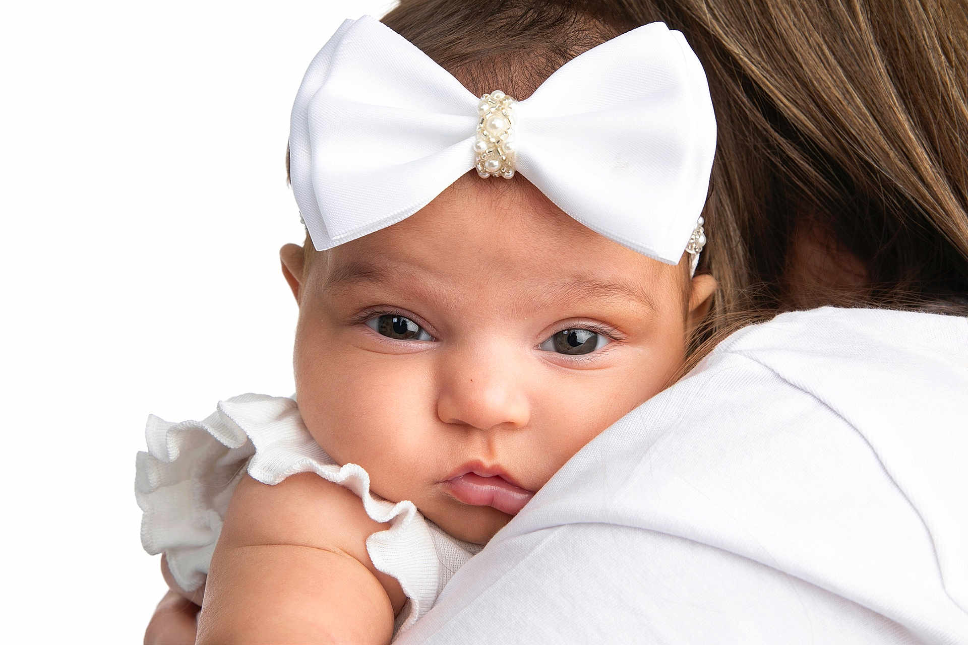 Kassie joined the competition — help win amazing prizes! baby, infant, child, white_bow, headband, close_up, portrait, face, skin, eyes, white_clothing, ruffles, shoulder, adult, person, cute, soft_skin, studio_lighting, isolated, expression