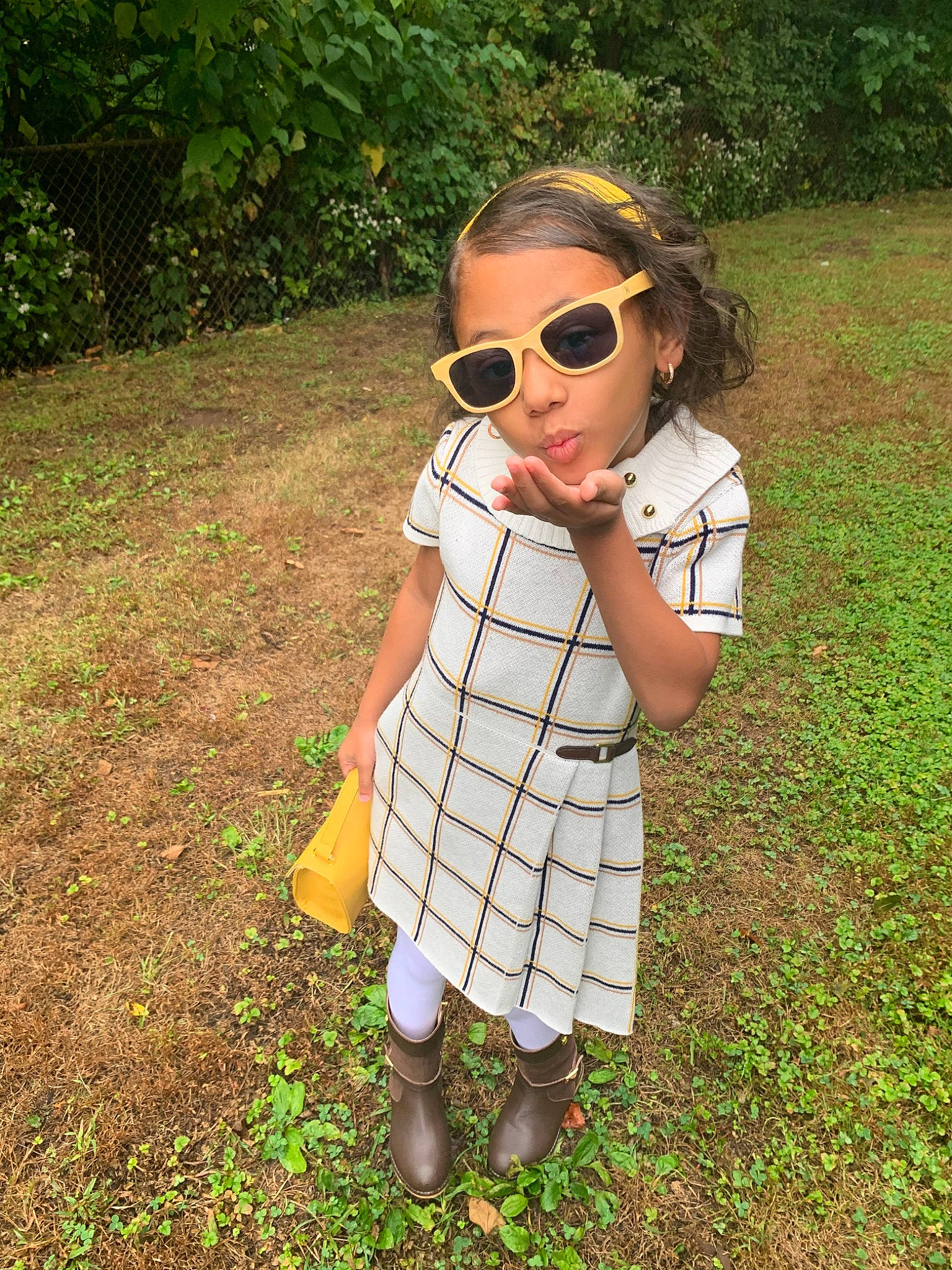 Aaliyah is registered to the contest to win money with this photo: child, cool, design, dress, eyewear, glasses, grass, pattern, person, plaid, plant, summer, sunglasses, toddler, vision_care, yellow