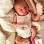 newborn, baby, sleeping, blanket, white_blanket, onesie, pink_mittens, infant, cute, peaceful, resting, soft_lighting, indoors, portrait, child, skin, head, closed_eyes, human, comfort