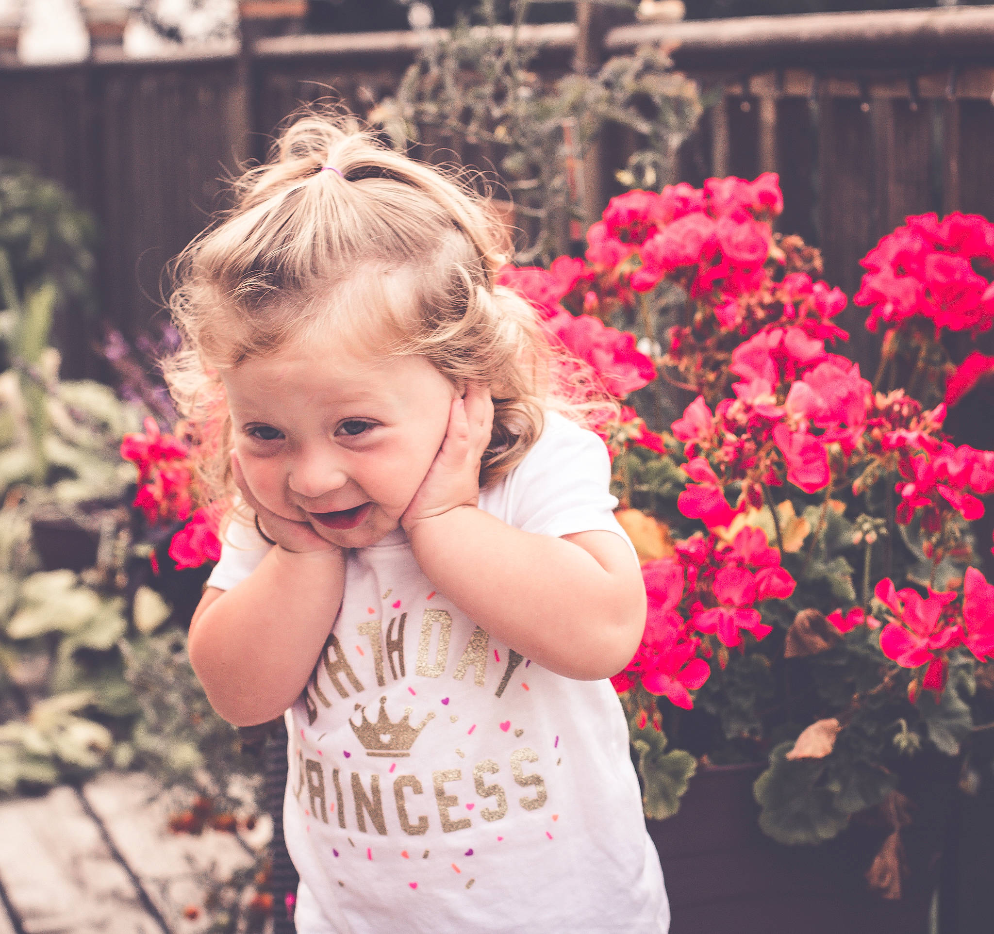 Brinlee is registered to the contest to win money with this photo: blond, child, day, facial_expression, flower, flower_arranging, fun, girl, hair, happiness, human_hair_color, joy, laughter, person, petal, pink, plant, skin, smile, spring