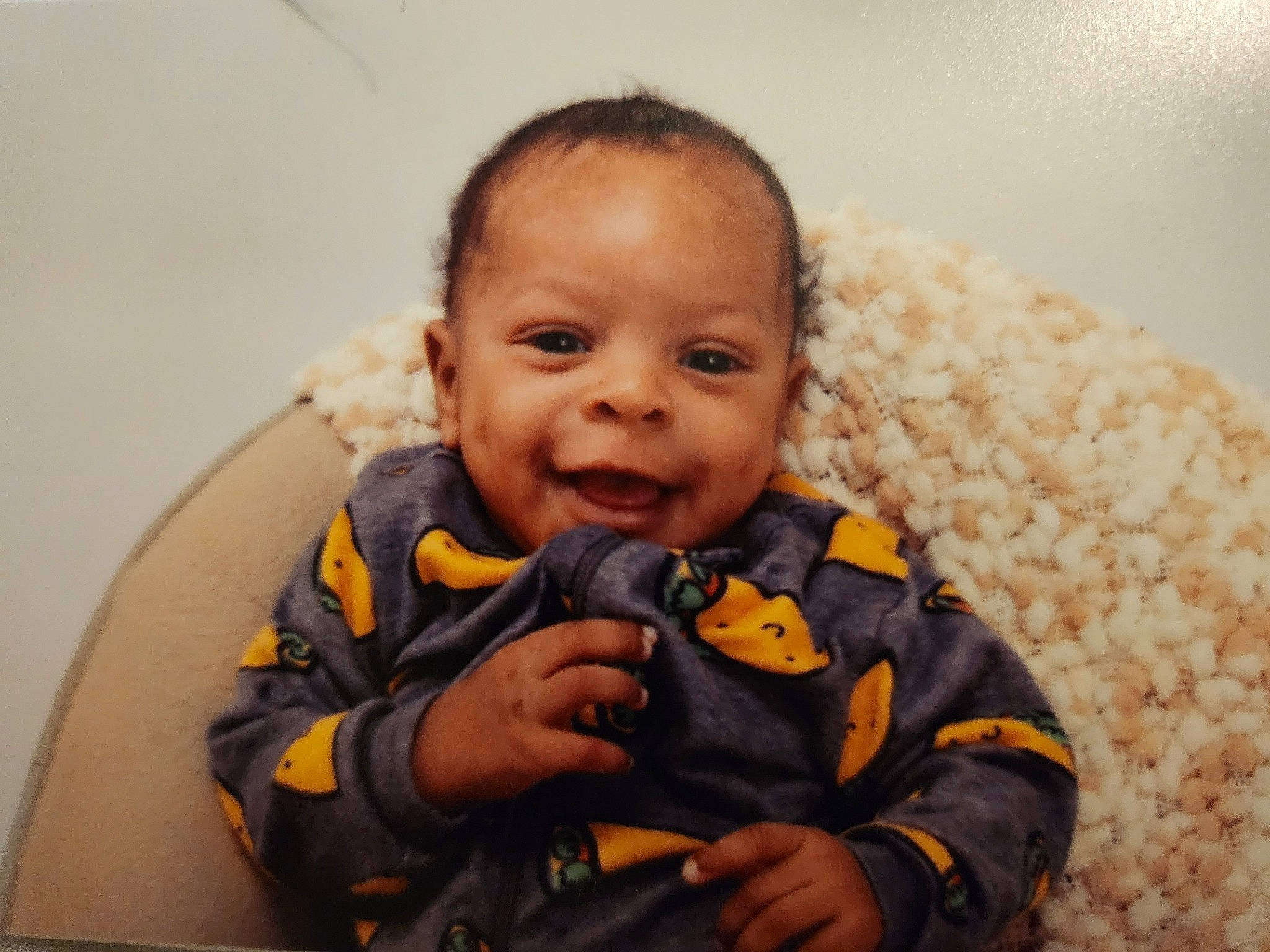 Kyng is registered to the contest to win money with this photo: baby, baby_toddler_clothing, cheek, child, comfort, eye, finger, fun, gesture, hairstyle, happy, iris, joy, mouth, nose, outerwear, person, sitting, skin, sleeve