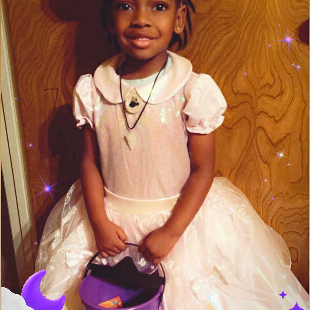 Dallas Dheir is registered to the contest to win money with this photo: accessories, bag, child, clothing, costume, dress, face, female, formalwear, girl, handbag, hat, head, indoors, jewelry, necklace, person, photography, portrait, purple