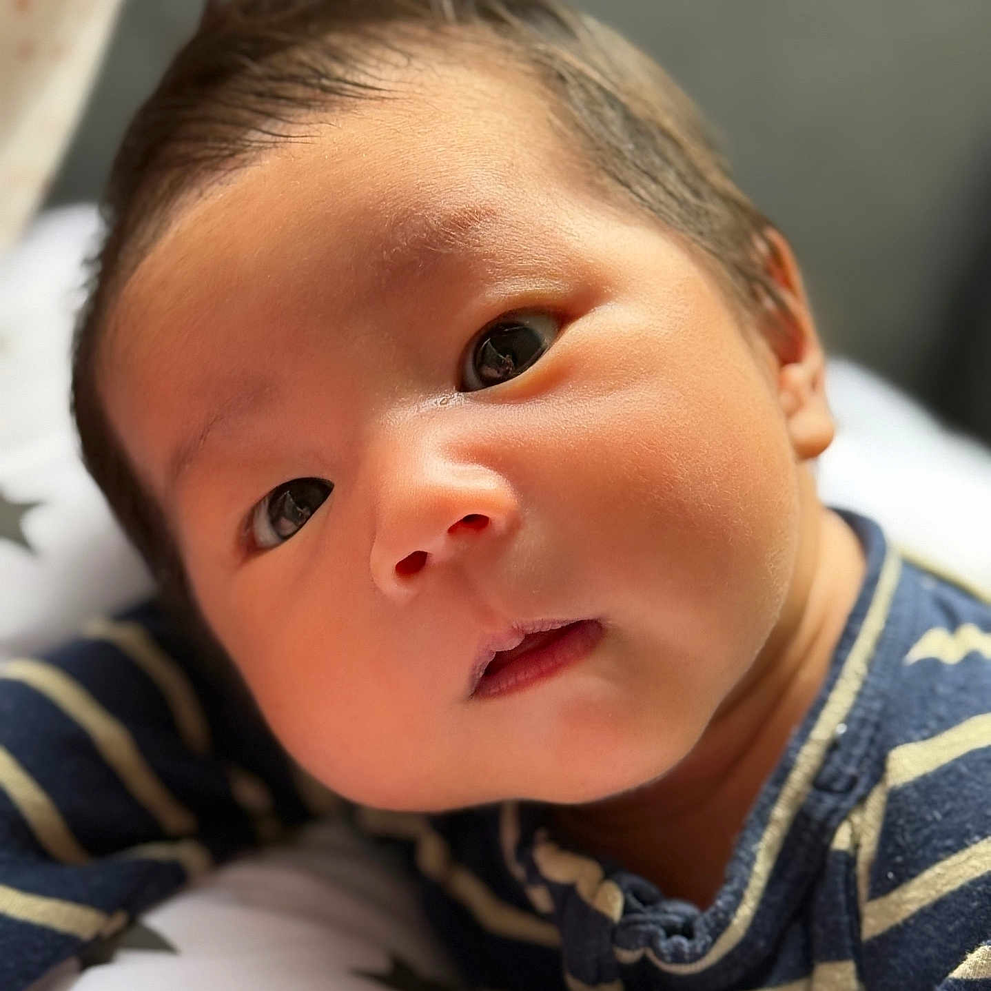 Gavin Alonzo joined the competition — help win amazing prizes! baby, child, closeup, clothing, cute, expression, eyes, face, indoors, infant, lying_down, newborn, person, pillow, portrait, skin, soft_light, stars, striped, young