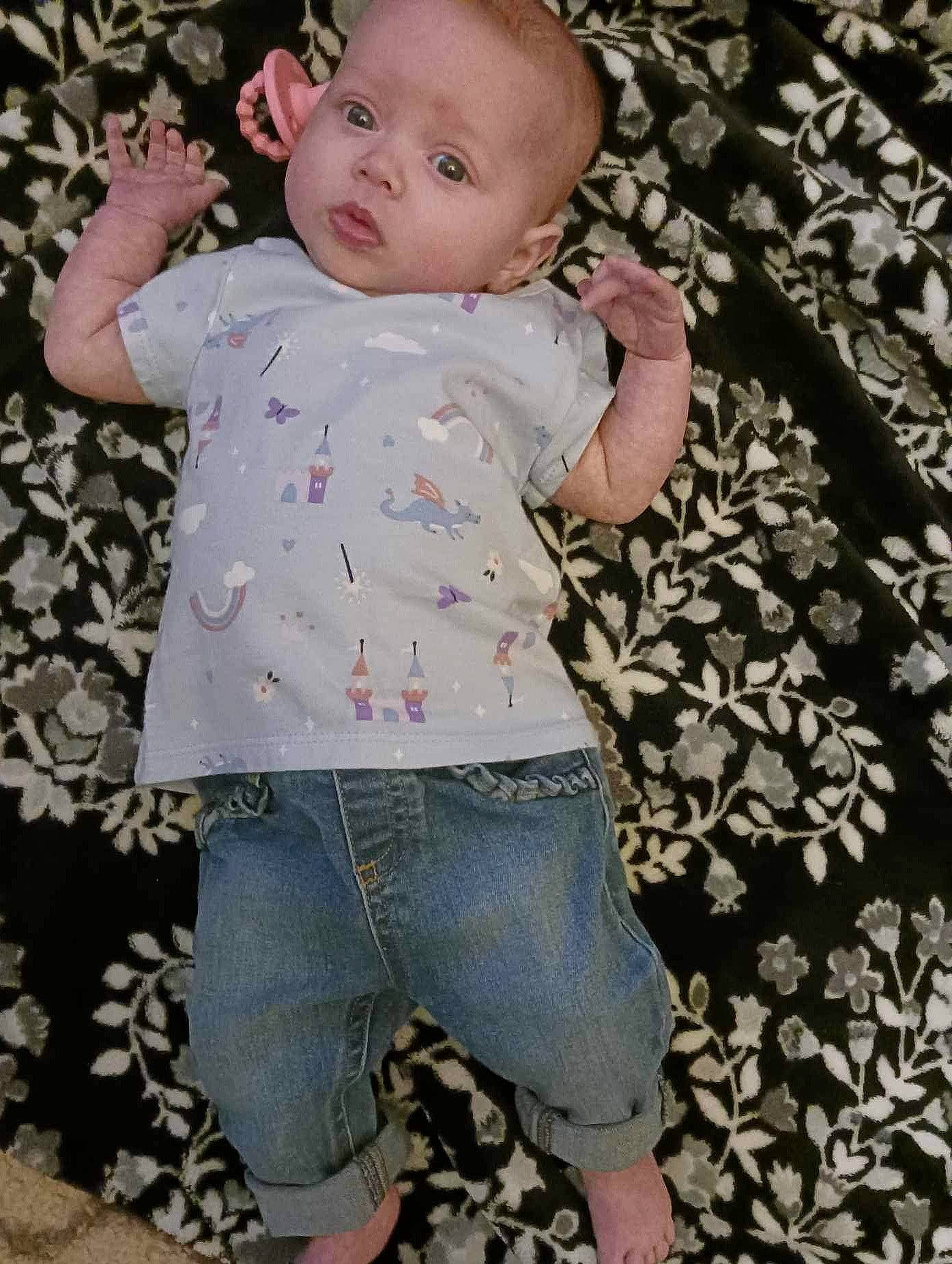 Olivia joined the competition — help win amazing prizes! arm, baby, baby_toddler_clothing, cheek, child, fun, gesture, grass, happy, pattern, people_in_nature, person, portrait_photography, skin, sleeve, t_shirt, textile, toddler, white