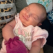 Delilah is registered to the contest to win money with this photo: newborn, baby, sleeping, infant, portrait, close_up, pink_clothing, onesie, disney, minnie_mouse, mitten, couch, cushion, blanket, indoors, cozy, peaceful, face, head, family_photo