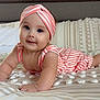 baby, child, portrait, smile, headband, striped_clothing, bed, pillow, crawling, cute, infant, happy, person, skin, indoors, apparel, lying_down, face, young, toddler