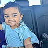 toddler, child, smile, car_seat, blue_shirt, beige_pants, bracelet, short_hair, happy, portrait, indoor, seat, person, casual_clothing, young_child, cute, baby, vehicle_interior, head, face