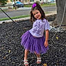 Alana joined the competition — help win amazing prizes! child, girl, toddler, portrait, outdoor, playground, tree, purple, bow, tutu, skirt, tshirt, sandals, smiling, standing, posing, residential_street, house, autumn, mulch