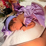 Mia joined the competition — help win amazing prizes! newborn, baby, purple_dress, headband, sleeping, blanket, flower, doll, soft_texture, indoors, infant, cute, peaceful, portrait, child, toddler, skin, hand, foot, decor