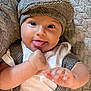 Elijah joined the competition — help win amazing prizes! baby, infant, face, tongue, hat, cap, clothing, suspenders, hand, smile, expression, cute, portrait, soft_texture, blanket, skin, cheeks, eyes, happy, indoors