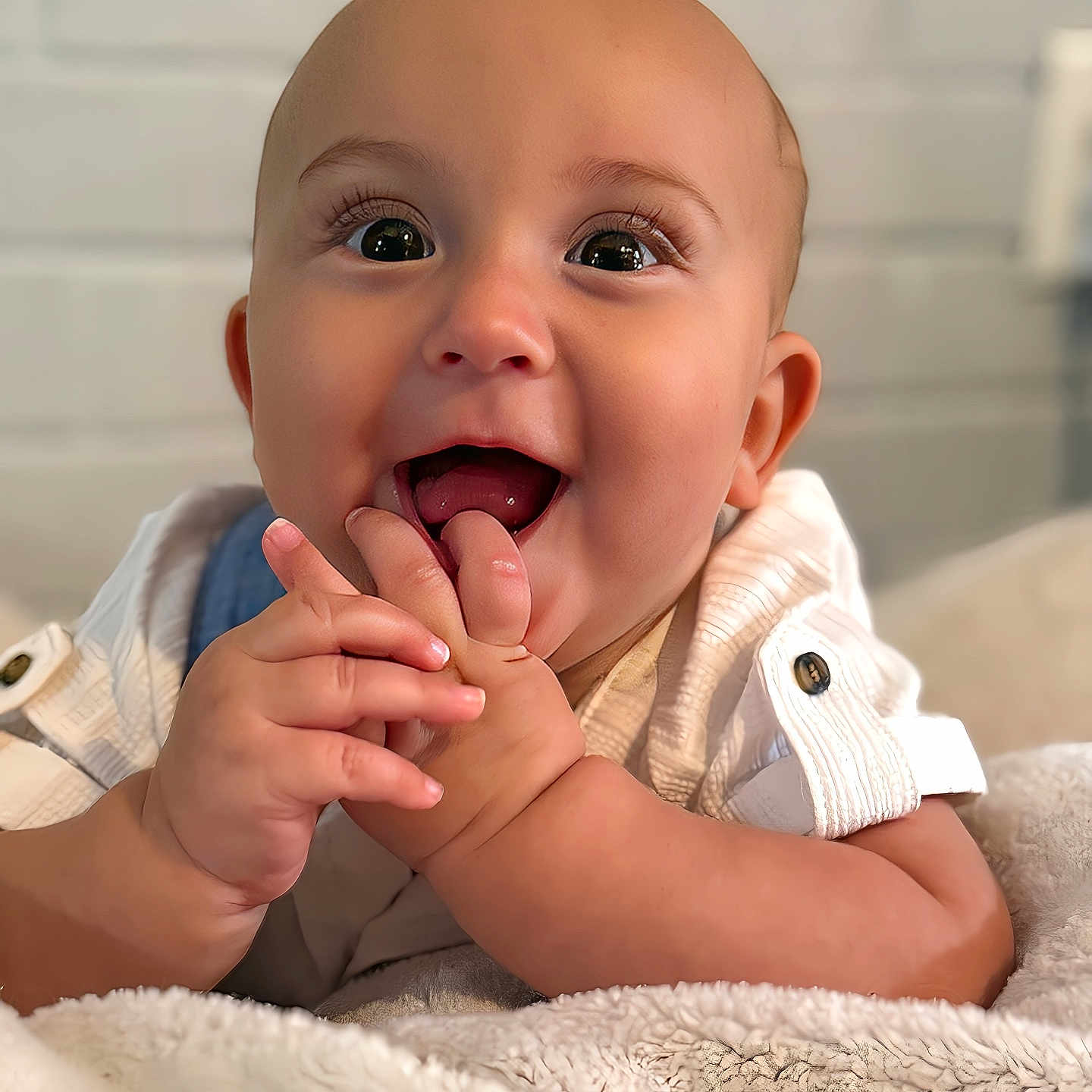 Elijah joined the competition — help win amazing prizes! baby, blanket, child, clothing, cute, expression, eyes, face, fingers, hands, happy, head, indoor, infant, mouth, portrait, skin, smiling, soft, white_shirt