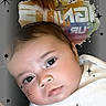 Robert joined the competition — help win amazing prizes! baby, infant, face, white_shirt, sparkles, stars, close_up, cute, child, portrait, expression, skin, hand, head, background, colorful_text, young, person, looking, soft_light
