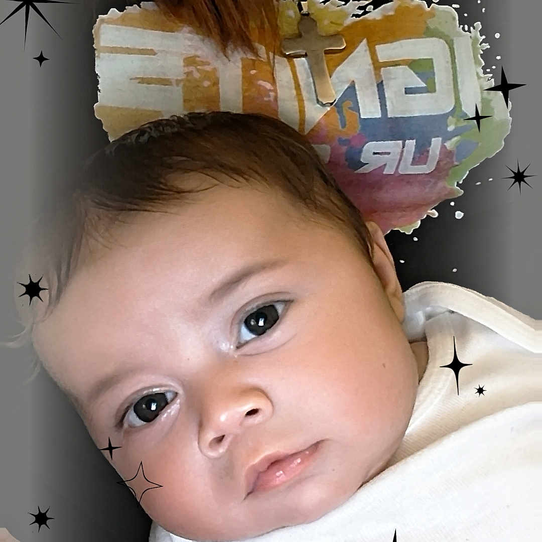 Robert joined the competition — help win amazing prizes! baby, infant, face, white_shirt, sparkles, stars, close_up, cute, child, portrait, expression, skin, hand, head, background, colorful_text, young, person, looking, soft_light