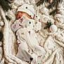 baby, christmas_theme, cozy, cute, festive, holiday, holiday_decor, holiday_pajamas, infant, knit_blanket, newborn, ornaments, peaceful, pine_branches, relaxing, sleeping, small, soft_texture, winter, wrapped